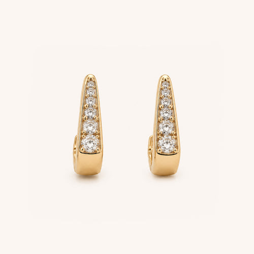 A pair of gold huggie  earrings, each adorned with a vertical row of round-cut clear gemstones, set against a clean off-white background.