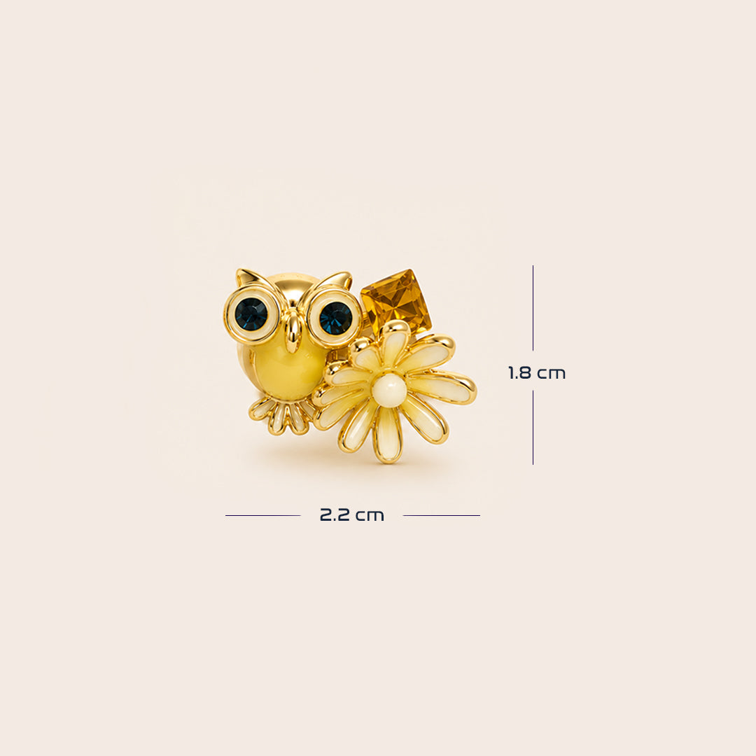 Gold owl and flower stud earring with dark blue and white gemstone accents, shown with sizing.