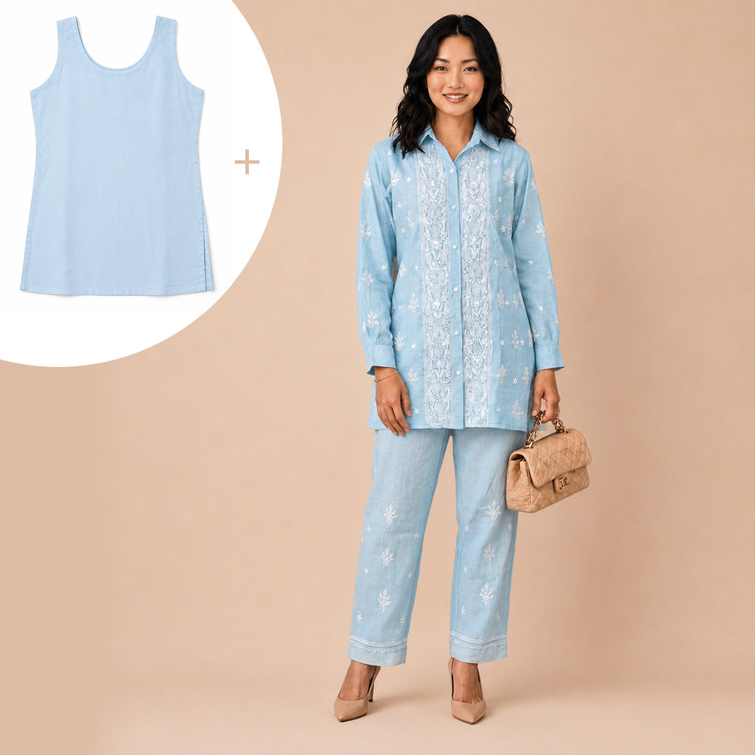 A woman models a light blue two-piece set consisting of a long-sleeve button-up shirt with white floral embroidery and matching light blue jeans with white floral embroidery. An inset in the top-left shows a matching light blue tank top.