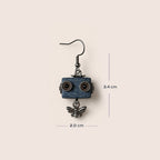A single dangling robot-eared earring with a blue rectangular face, dark metal wire eyes, and a dangling bee charm, shown on a light beige background with measurement lines indicating 3.4 cm height and 2.