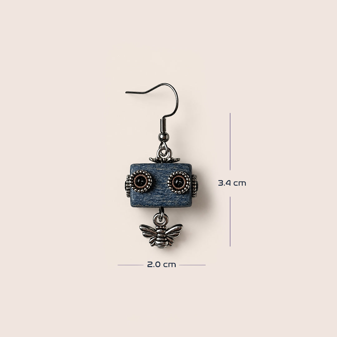 A single dangling robot-eared earring with a blue rectangular face, dark metal wire eyes, and a dangling bee charm, shown on a light beige background with measurement lines indicating 3.4 cm height and 2.