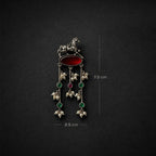 A silver-toned traditional Indian pendant featuring a horse motif, a red oval stone, and three dangling floral clusters with green and red stones and pearl-like beads. Measurement annotations indicate 7.